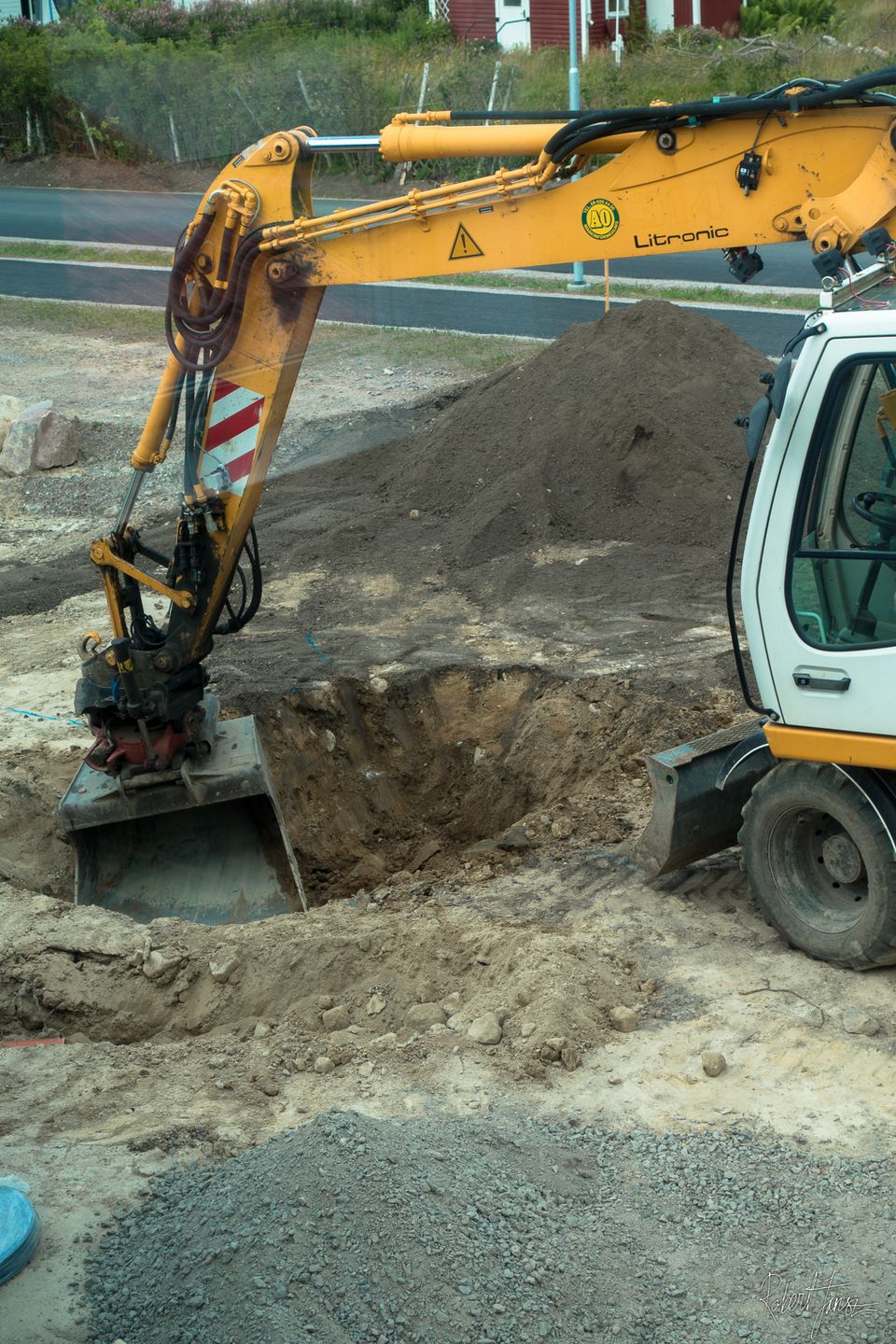 Excavator digging the hole for the trampoline