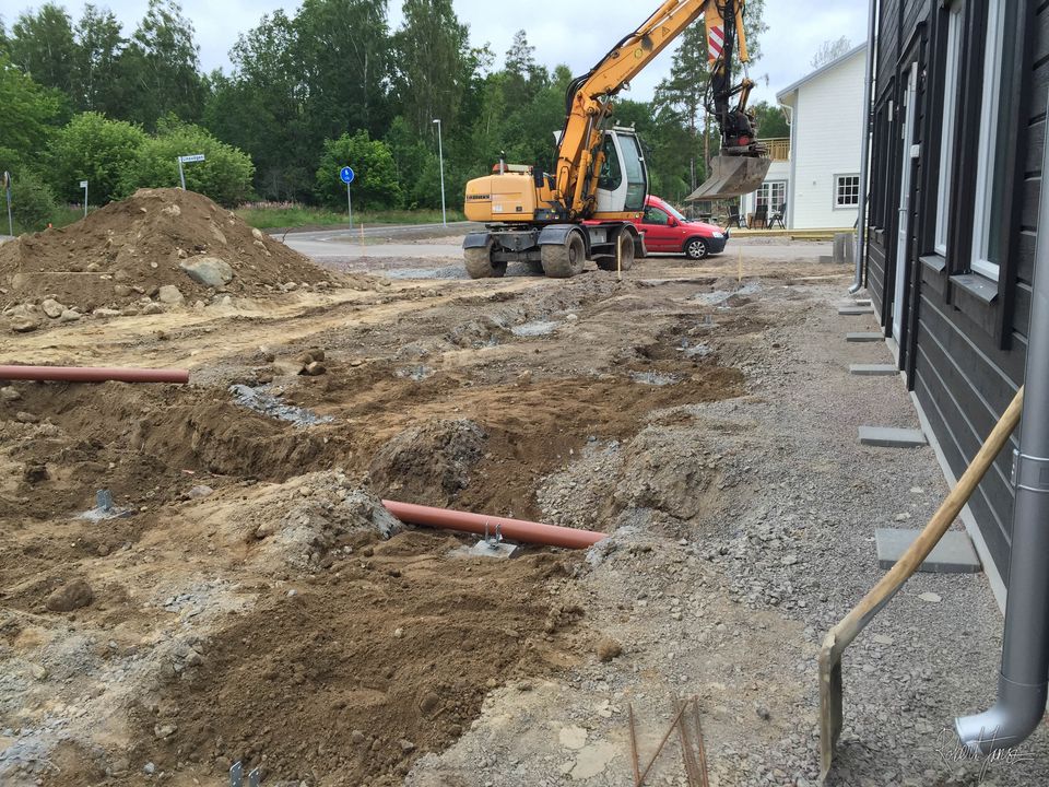 The concrete plinths buried in gravel and soil
